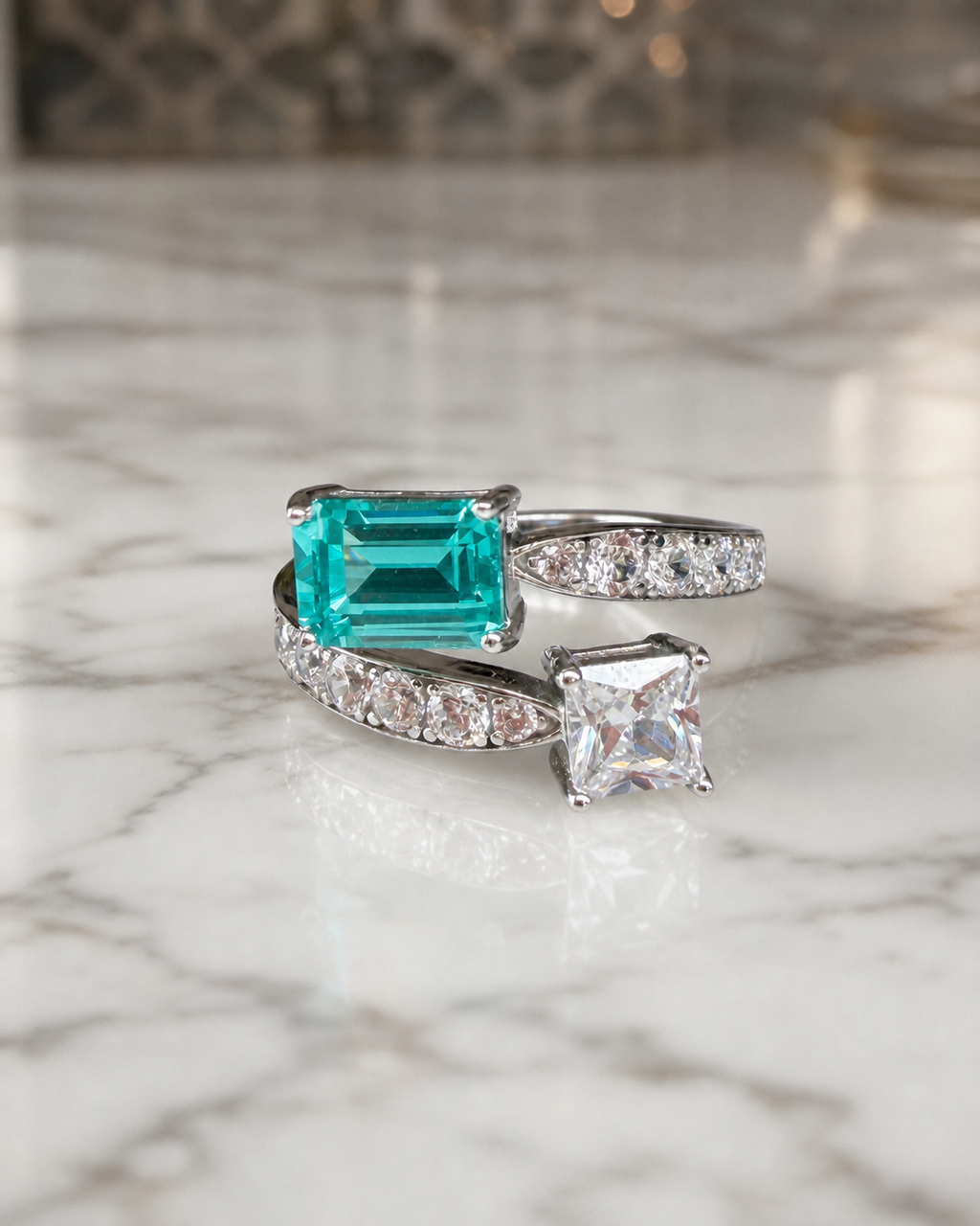 Paraiba-blue and white two-stone Toi et Moi ring in rhodium-finished sterling silver, on marble