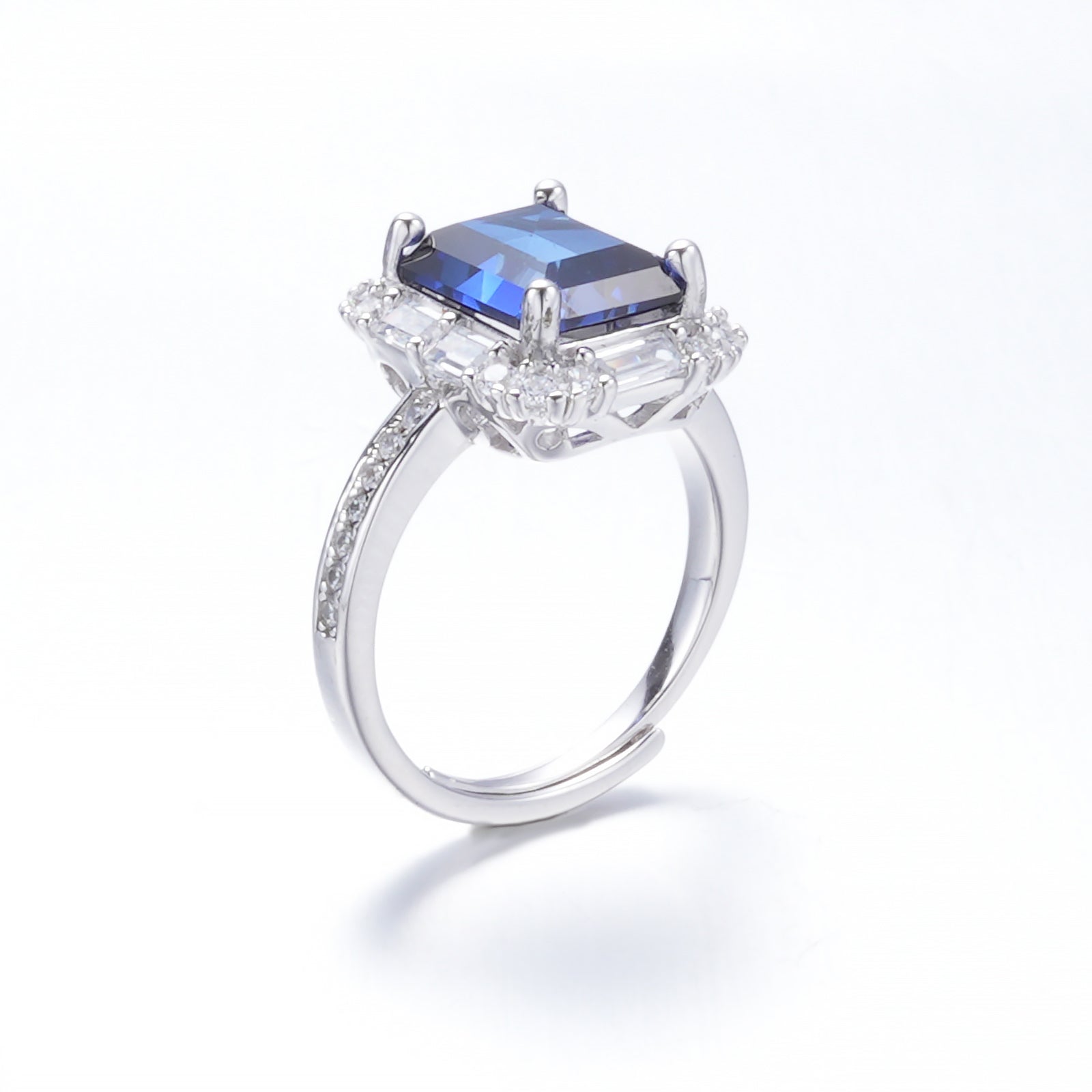 The Modern Halo — emerald-cut blue sapphire ring with halo setting in 925 sterling silver