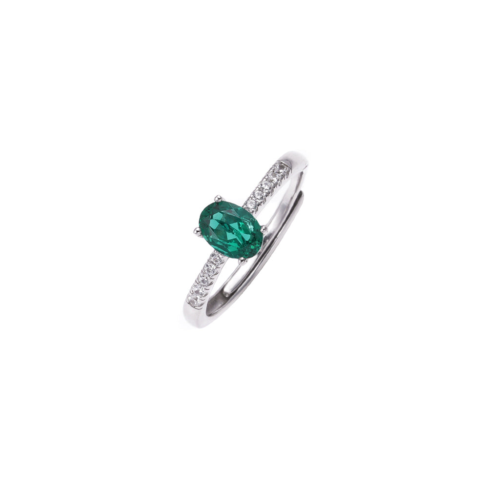 The Emerald Solitaire oval emerald-green ring side view by Iris & Carly
