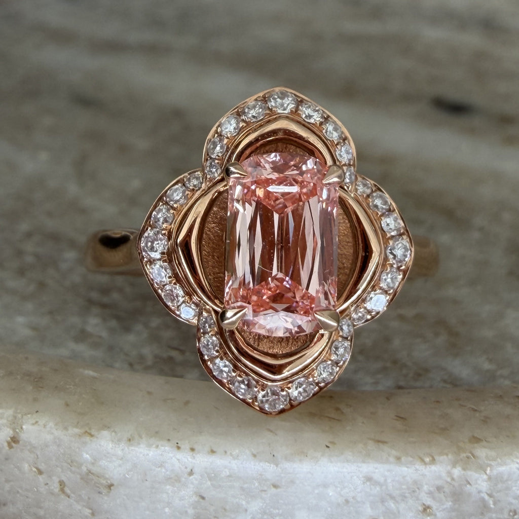 The Pink Blossom ring shown from a slightly angled front view, showing the radiant-cut pink diamond centre