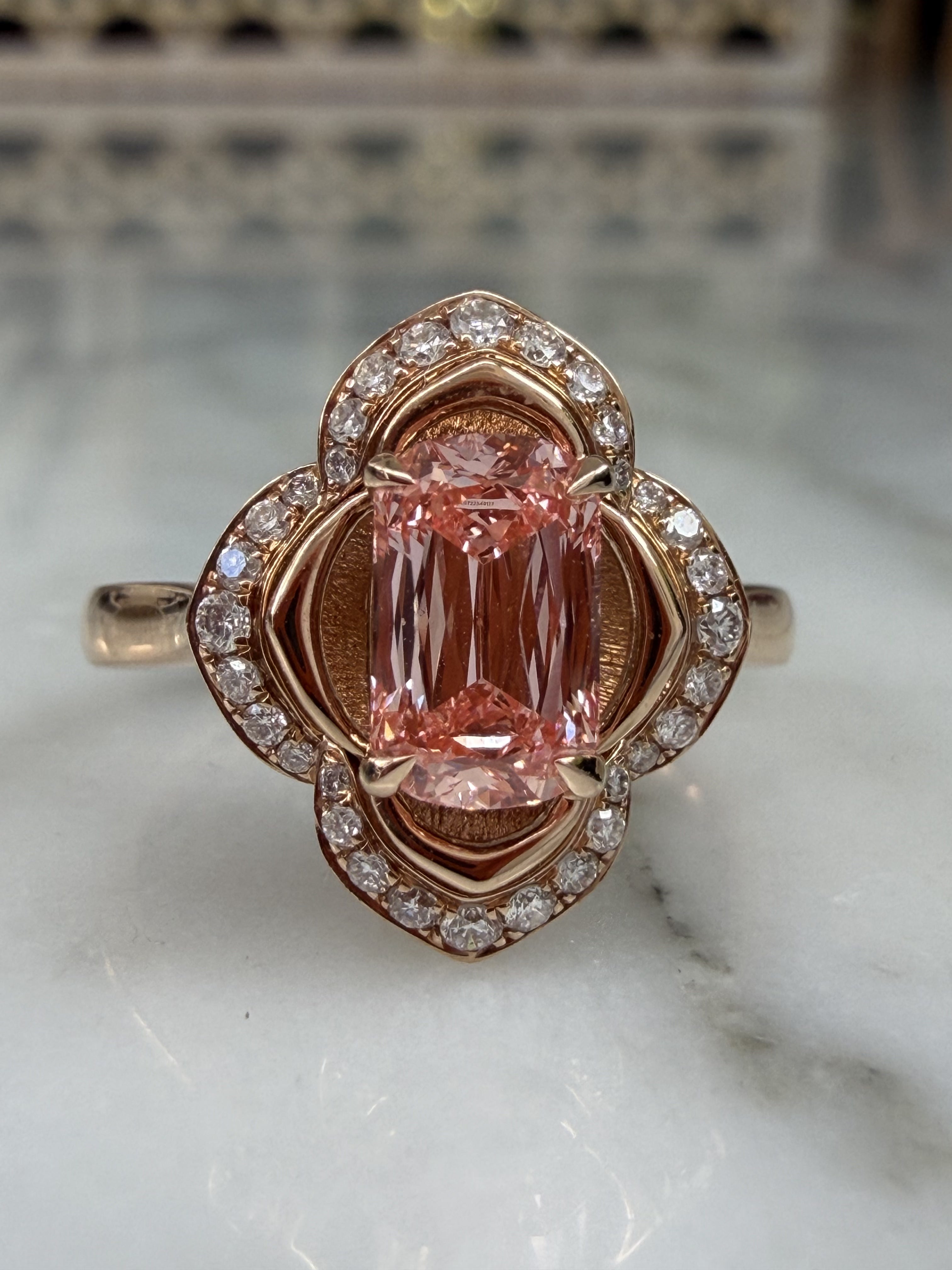 Macro view of the pink lab-grown diamond centre stone in The Pink Blossom, showing the IGI laser inscription on the girdle