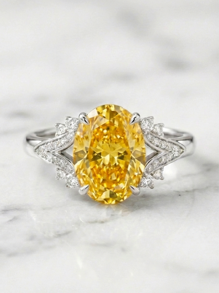 The Sunburst yellow diamond ring front view on white marble, showing the sunburst diamond cluster split shank