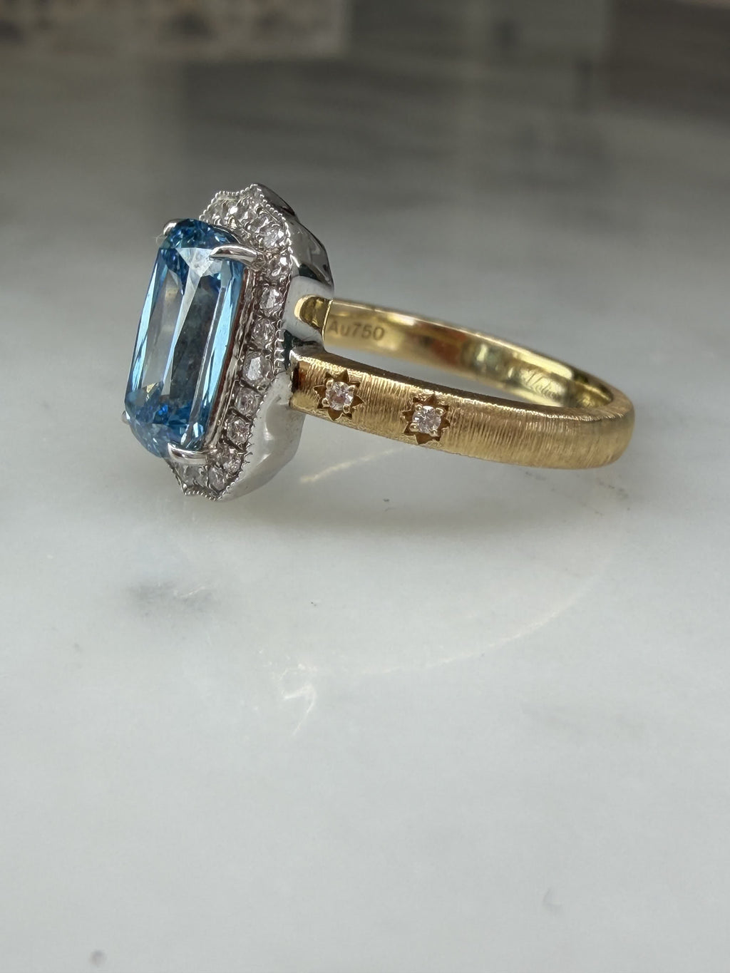 Profile of The Tidal Vow showing the scalloped diamond halo and blue diamond centre